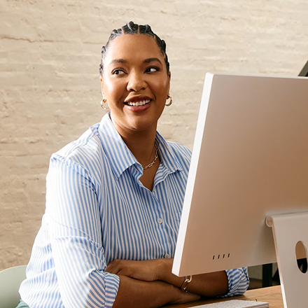 Woman sitting at computer smiling