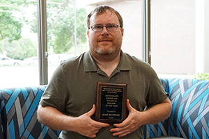 Adam Whitmore, an adjunct mechatronics instructor at the Central Community College, holds the Outstanding Career and Technical Teacher of the Year Award