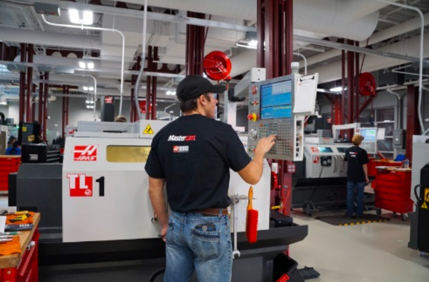 Man working on a CNC in a factory