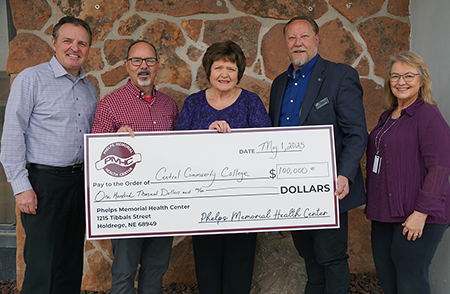 Group holds donation check from Phelps Memorial for $100,000 to support Central Community College