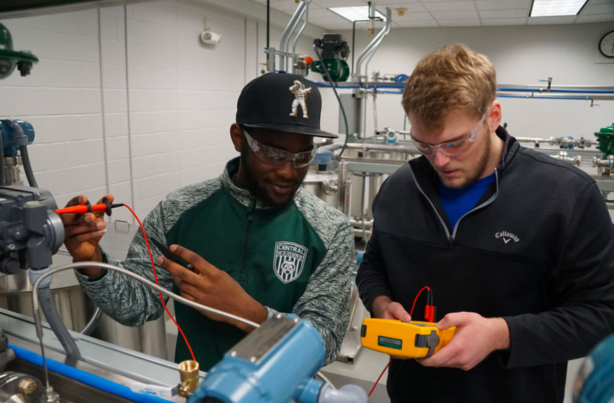 Two students working on mechatronics in lab during class