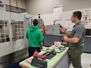 Reviewing a CNC machine during class at CCC.