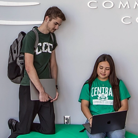 Two students looking at a laptop