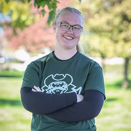 Female student on campus with her arms folded