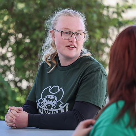 Student sitting outside during the school day at CCC