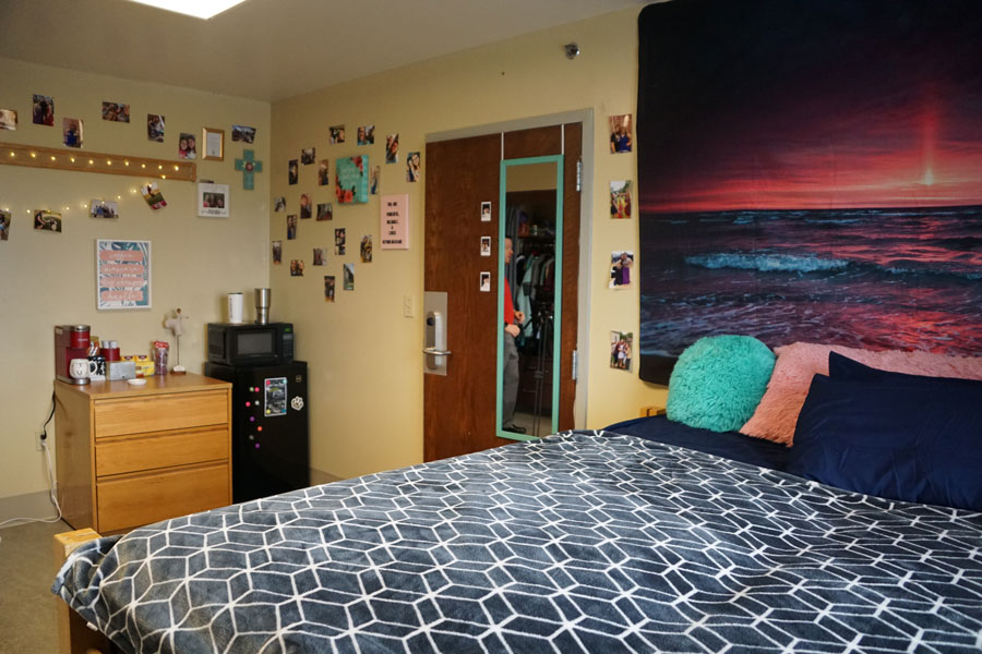 Bed and entrance area in a Columbus Campus dorm room.