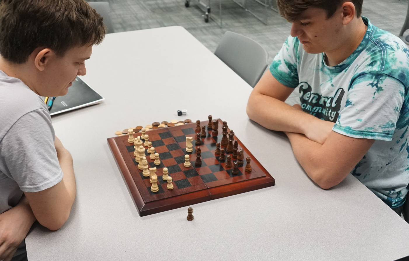 Two students playing chess during a break while attending tutoring at the Academic Success Center.