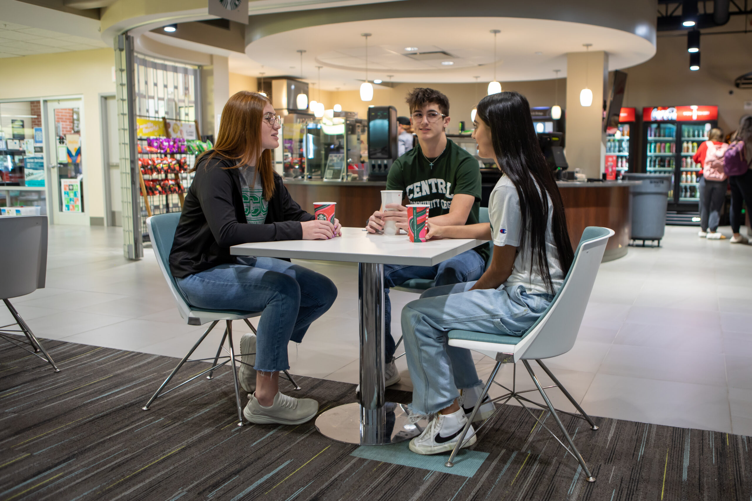 Four students sit in lunch room between classes.