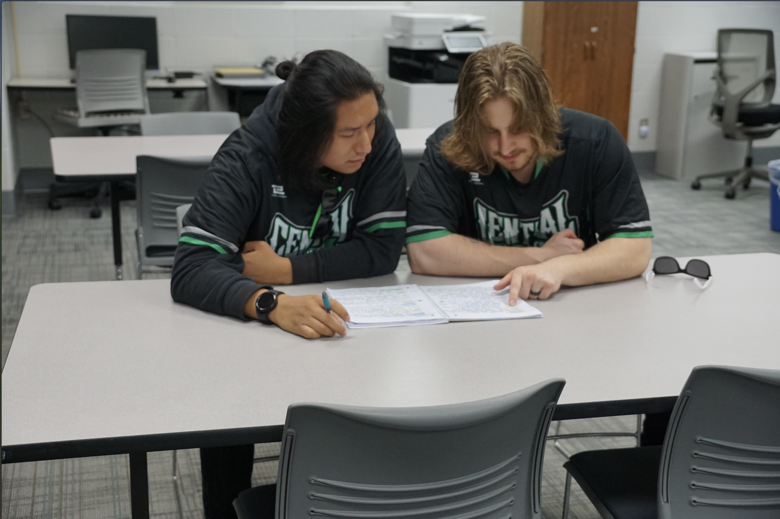 Two male students reviewing their notes at the Academic Success Center