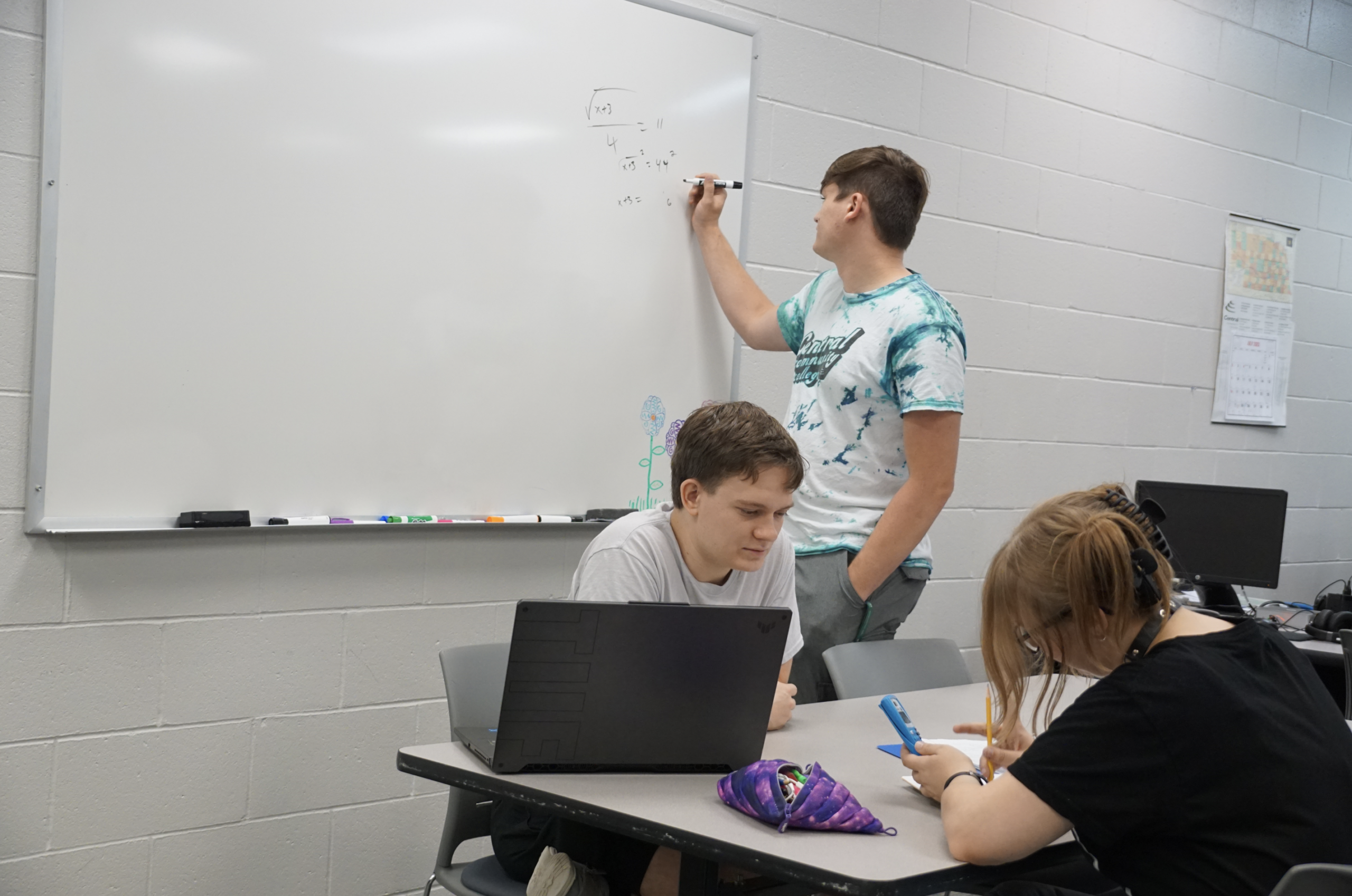 Student writing on a whiteboard in the Academic Success Center