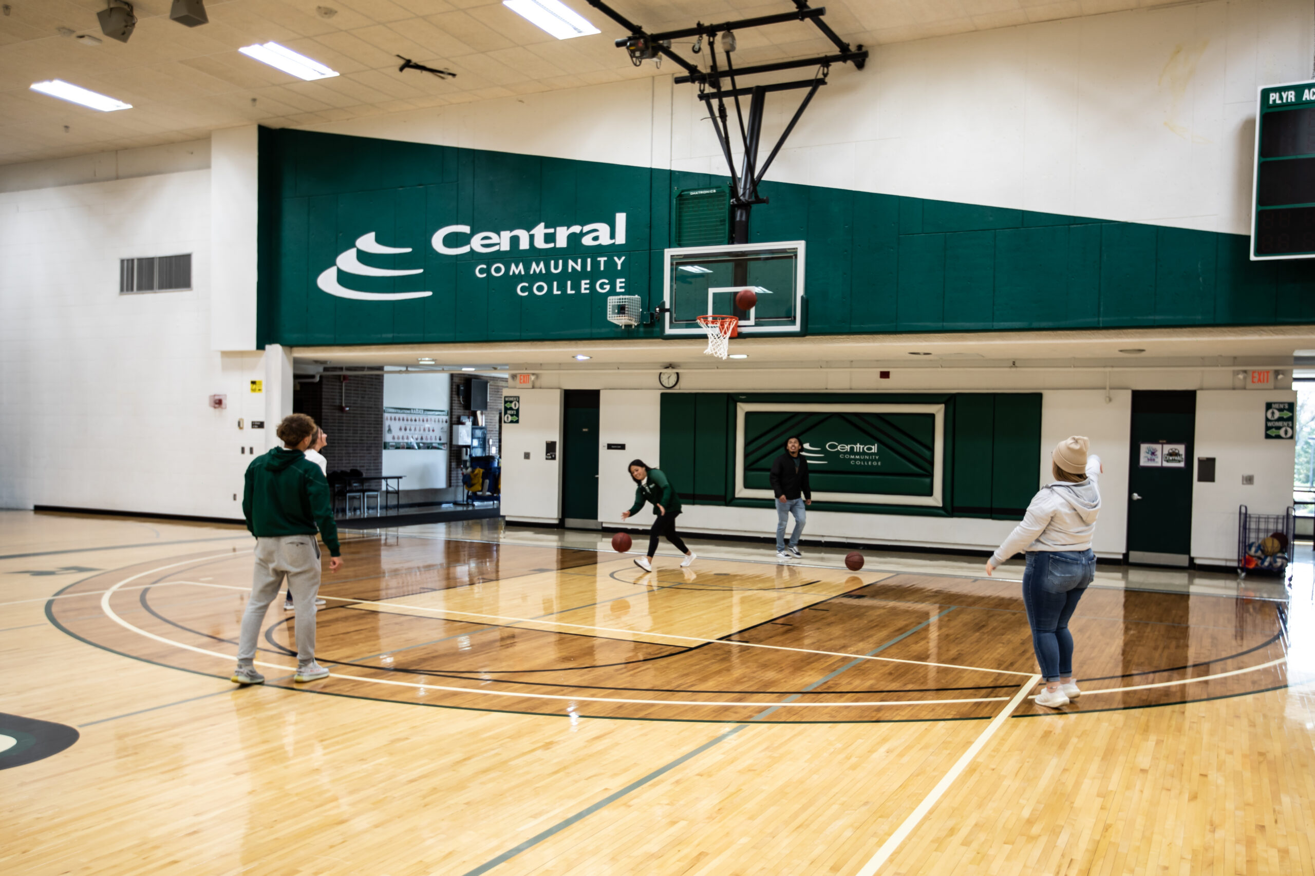 Students playing basketball in gym