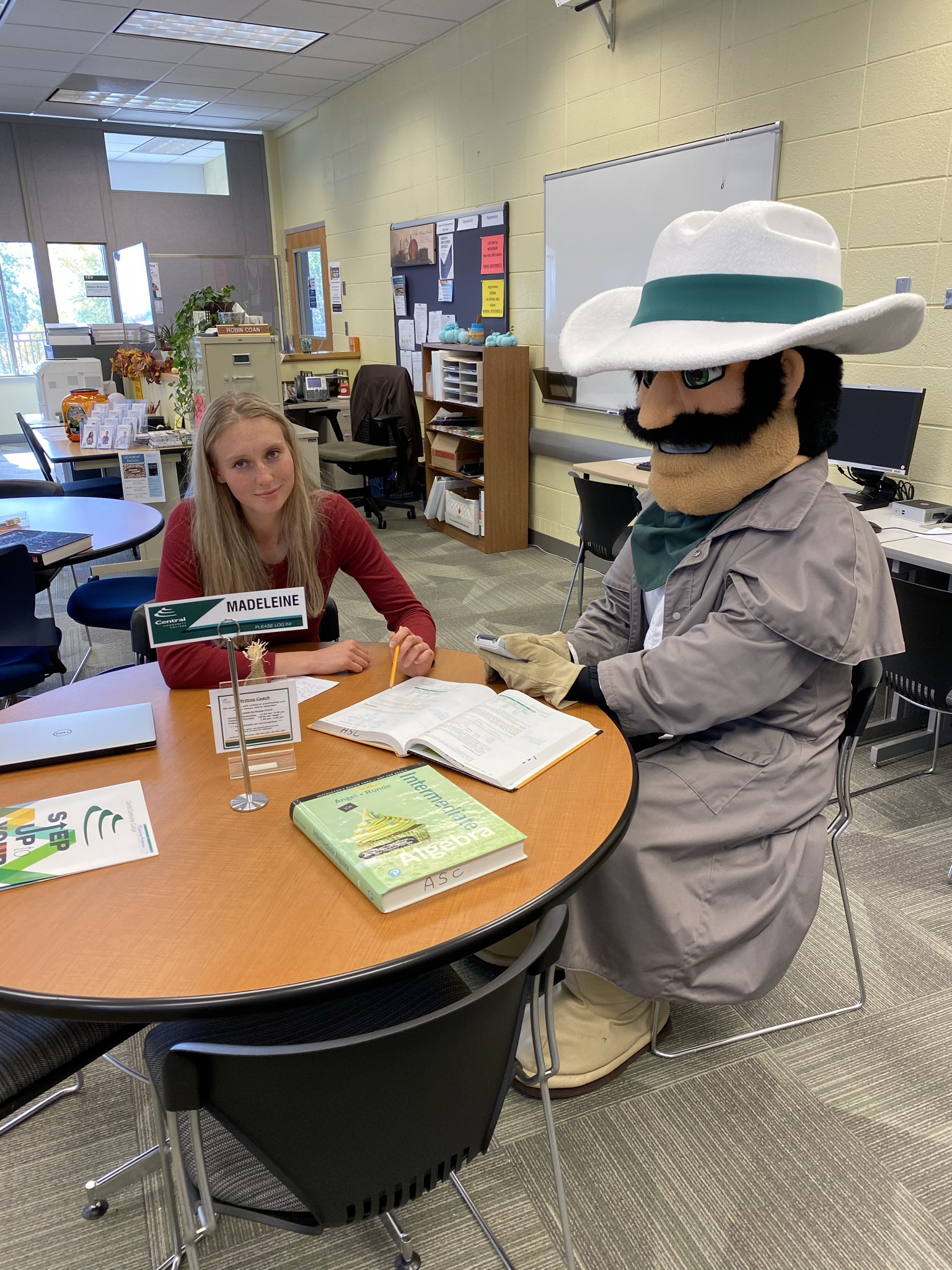 Tutor sits at a table in the Academic Success Center - Columbus