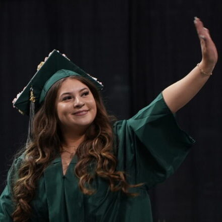 Graduate waves as walking in ceremony