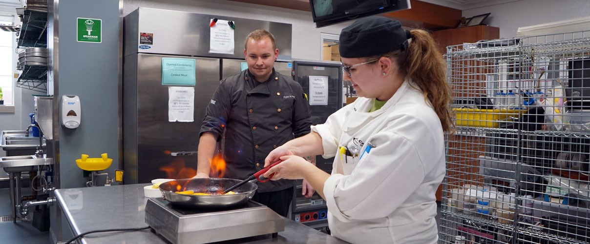 Student demonstrating Flambé technique.