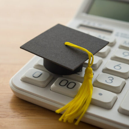 Little graduation cap sitting on a calculator