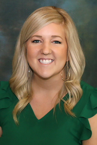 Portrait of Kara Greenwalt in a green blouse.