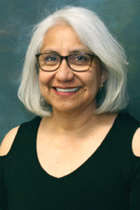 Portrait of Maria Lopez on a grey background.