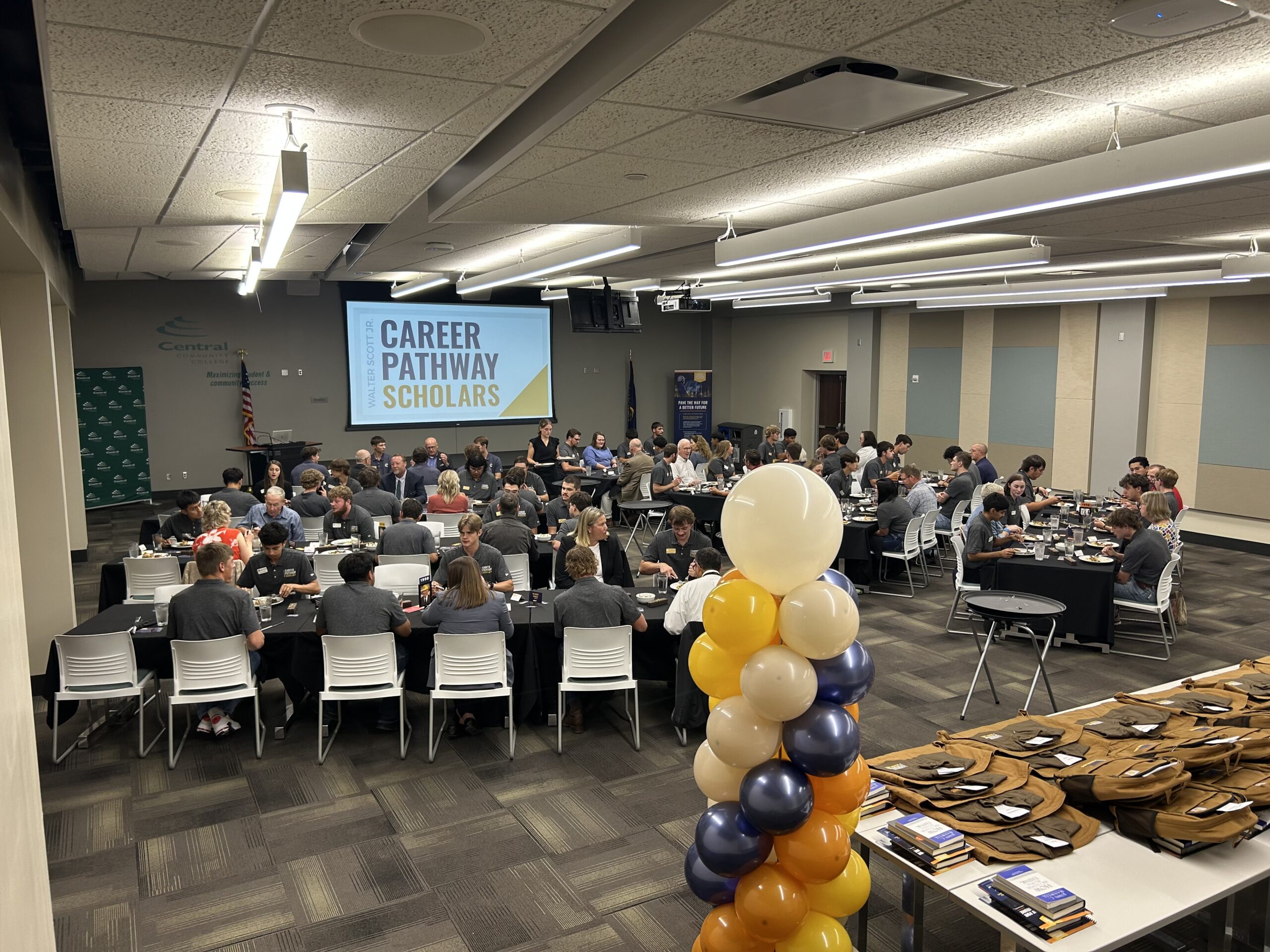 Students seated at long tables during a Career Pathway Scholars kickoff program.