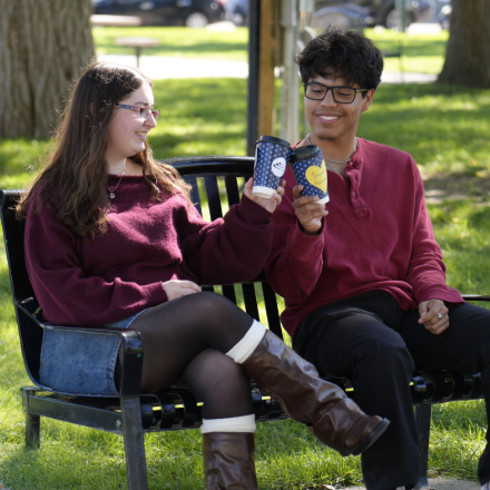 Theatre students sitting together on a park bench 